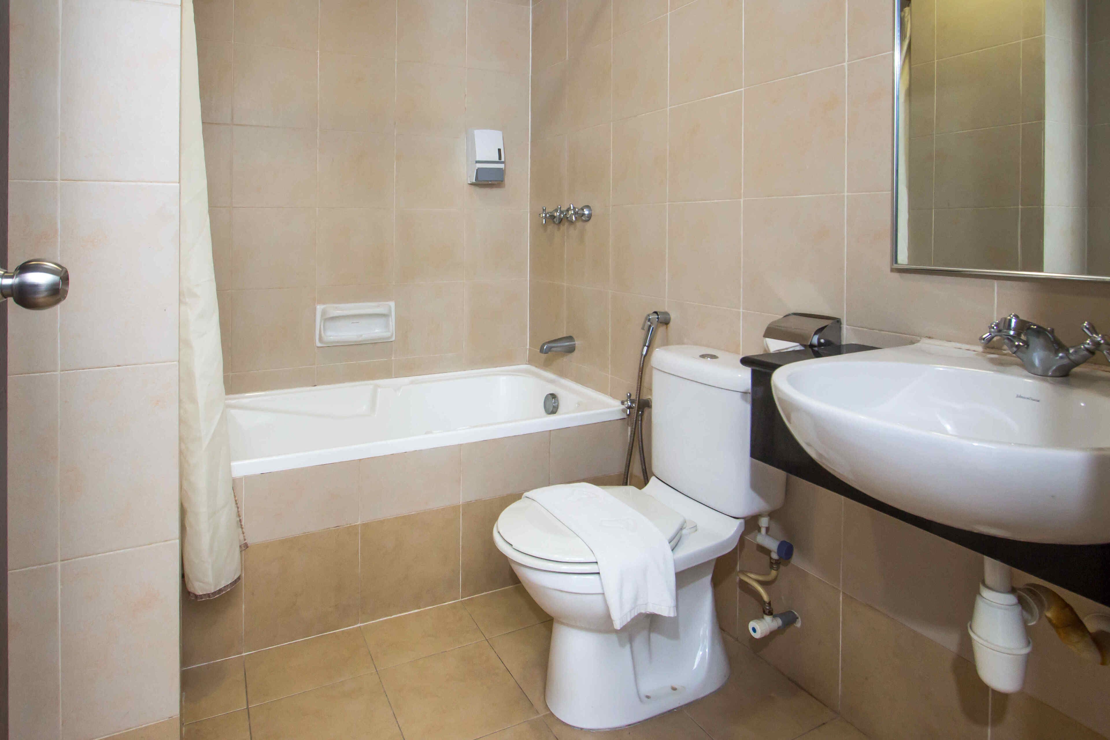 A bathroom with a bathtub, toilet, and sink.