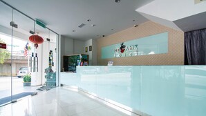 A hotel reception area with a glass partition, a reception desk, and a sign reading "Dreamz Hotel". - Hotel Zamburger Plaza Mahkota (Malacca City)