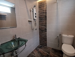 A bathroom with a glass sink, a shower with a control panel, and a toilet. - Hotel Zamburger Mariam Melaka (Malacca City)