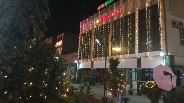 A hotel with a sign reading "HOTEL EKANT" and a well-lit facade. - Hotel Ekant (Faridabad)