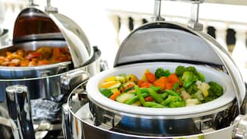Two covered food dispensers with a variety of vegetables.