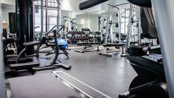 A gym with various exercise equipment, including weight machines and free weights.