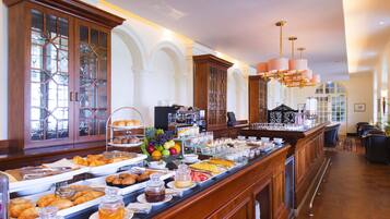 A buffet with various food items and a coffee station.