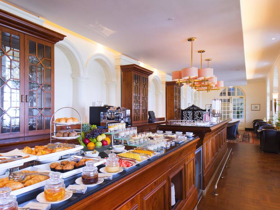 A buffet with various food items and a coffee station.