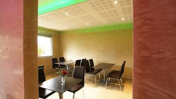 A conference room with a table, chairs, and a window.