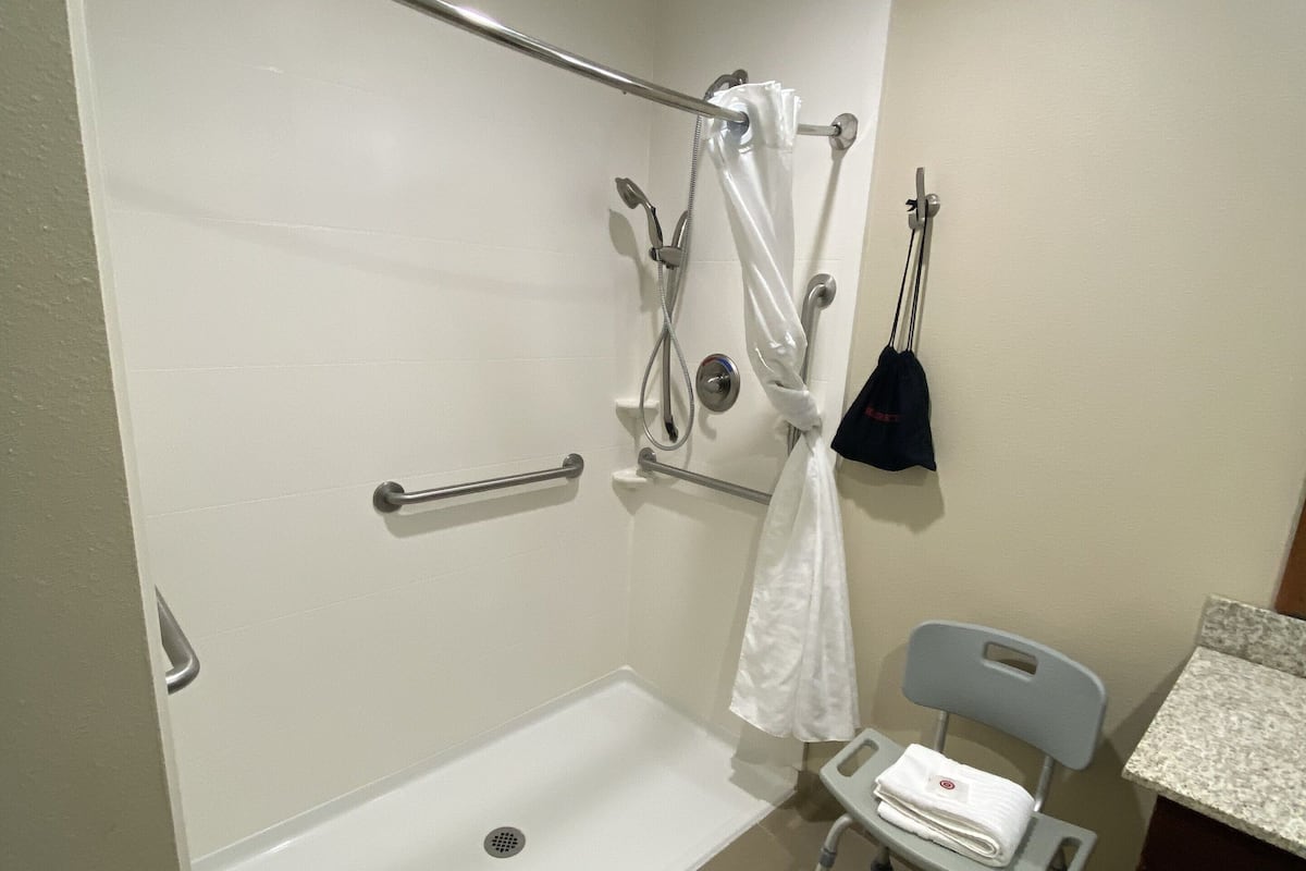 suite, 1 king bed with sofa bed, accessible, non smoking | bathroom | free toiletries, hair dryer, towels