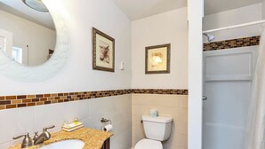 A bathroom with a sink, toilet, and shower.
