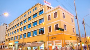A multi-story hotel with a yellow facade, multiple windows, and a visible sign indicating it is a hotel. - Colon Plaza Hotel (Ica)