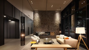 A modern living room with a fireplace, seating, and a large window. - Shilla Stay Mapo Hongdae (Seoul)