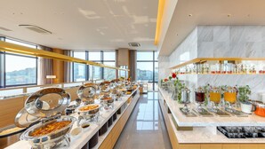 A buffet with various food stations and a beverage bar, set in a modern hotel with large windows and a marble interior. - Candeo Hotels Matsuyama Okaido (Matsuyama)