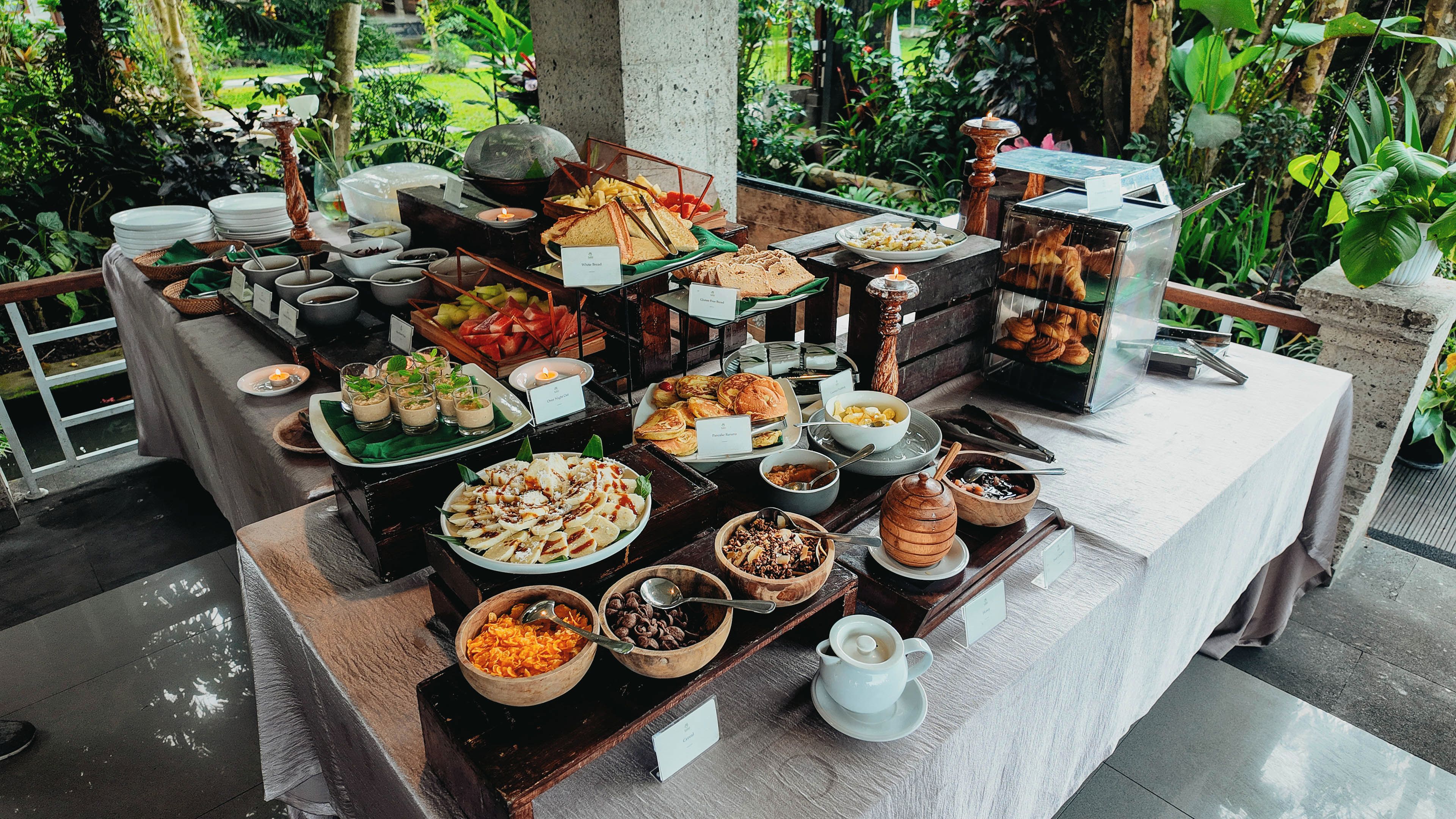 A buffet with various food items and a coffee station.