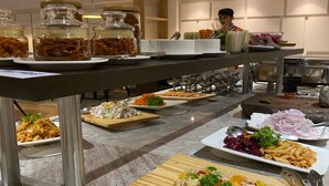 A buffet setup with various dishes and condiments. - Sterling Nainital (Nainital)