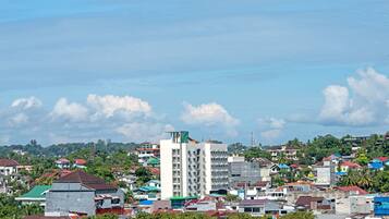 A densely built urban area with a mix of residential and commercial buildings, including a prominent white high-rise.