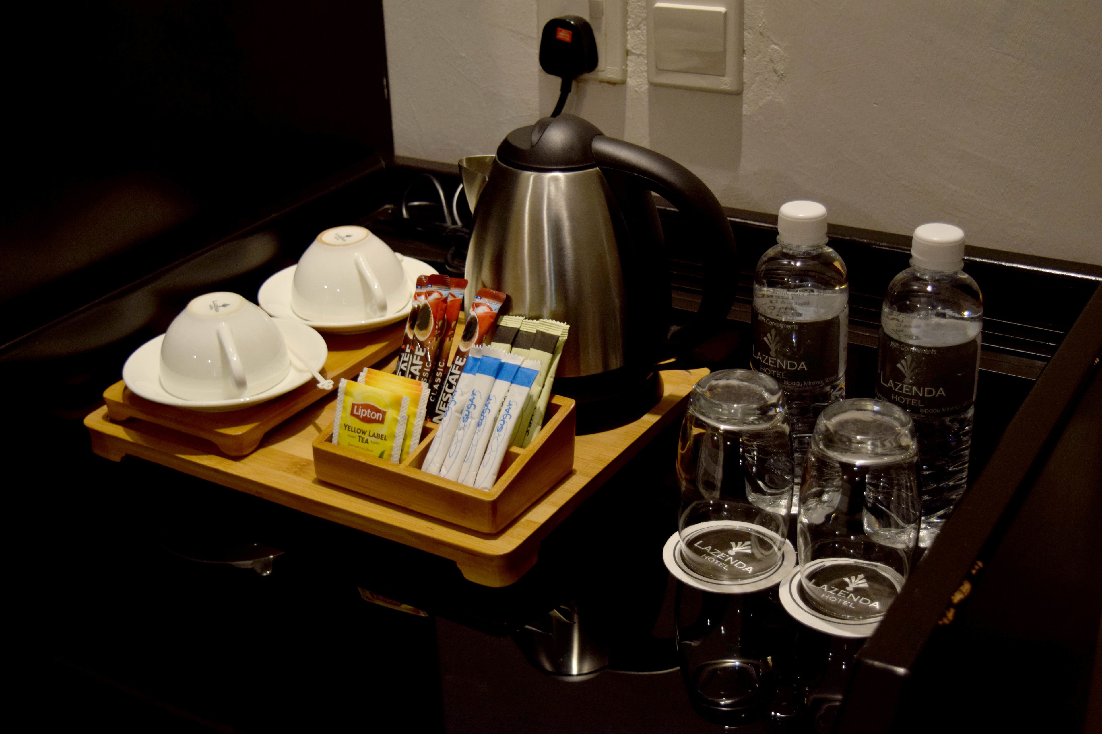 deluxe room | minibar, in-room safe, desk, iron/ironing board