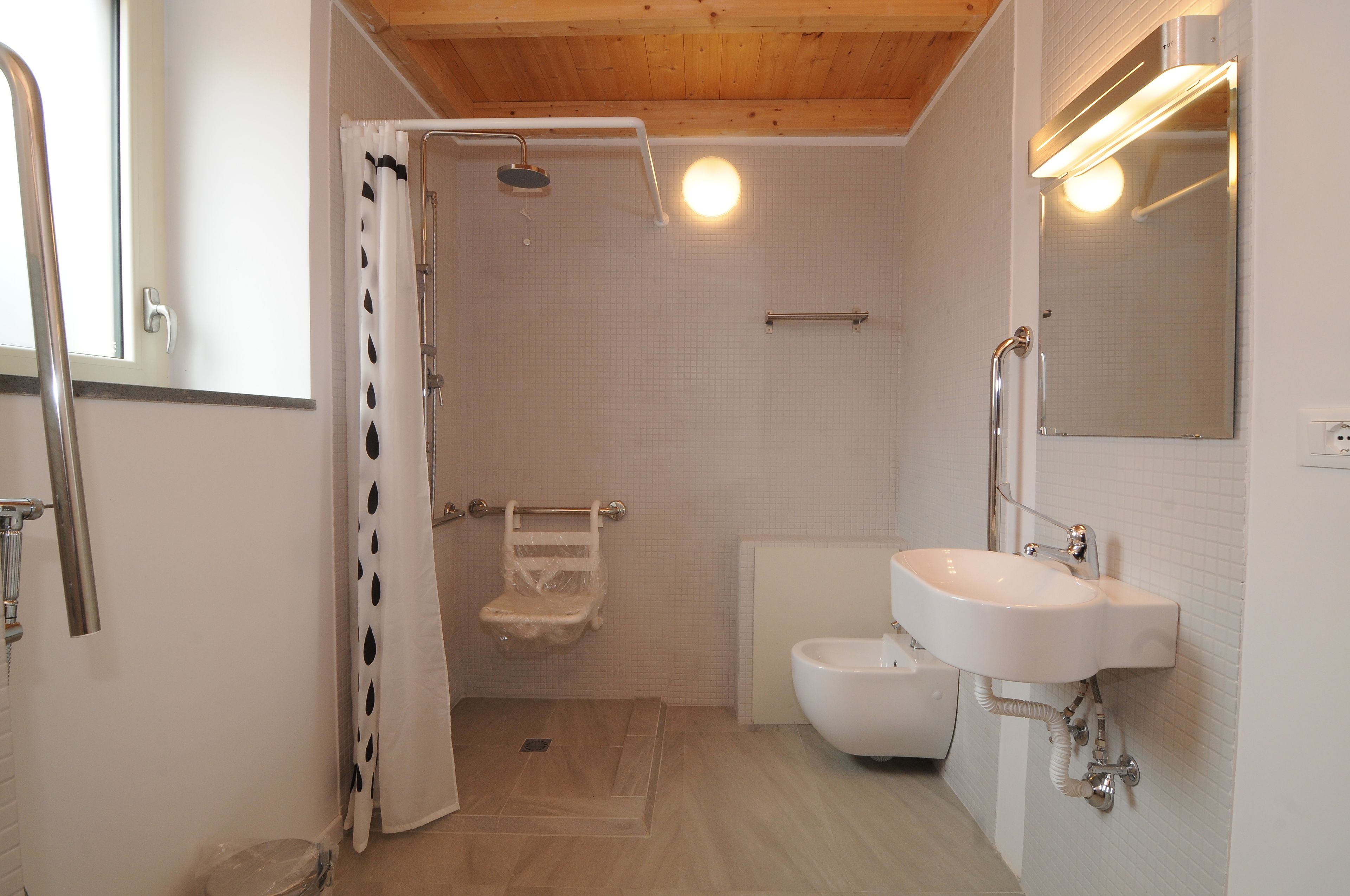 A bathroom with a shower, toilet, and sink.