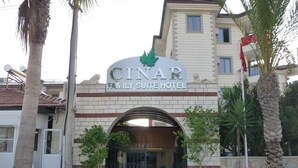 The entrance to the Cinar Family Suite Hotel with a prominent sign, a gated entrance, and surrounding palm trees. - Çınar Family Suite Hotel (Manavgat)