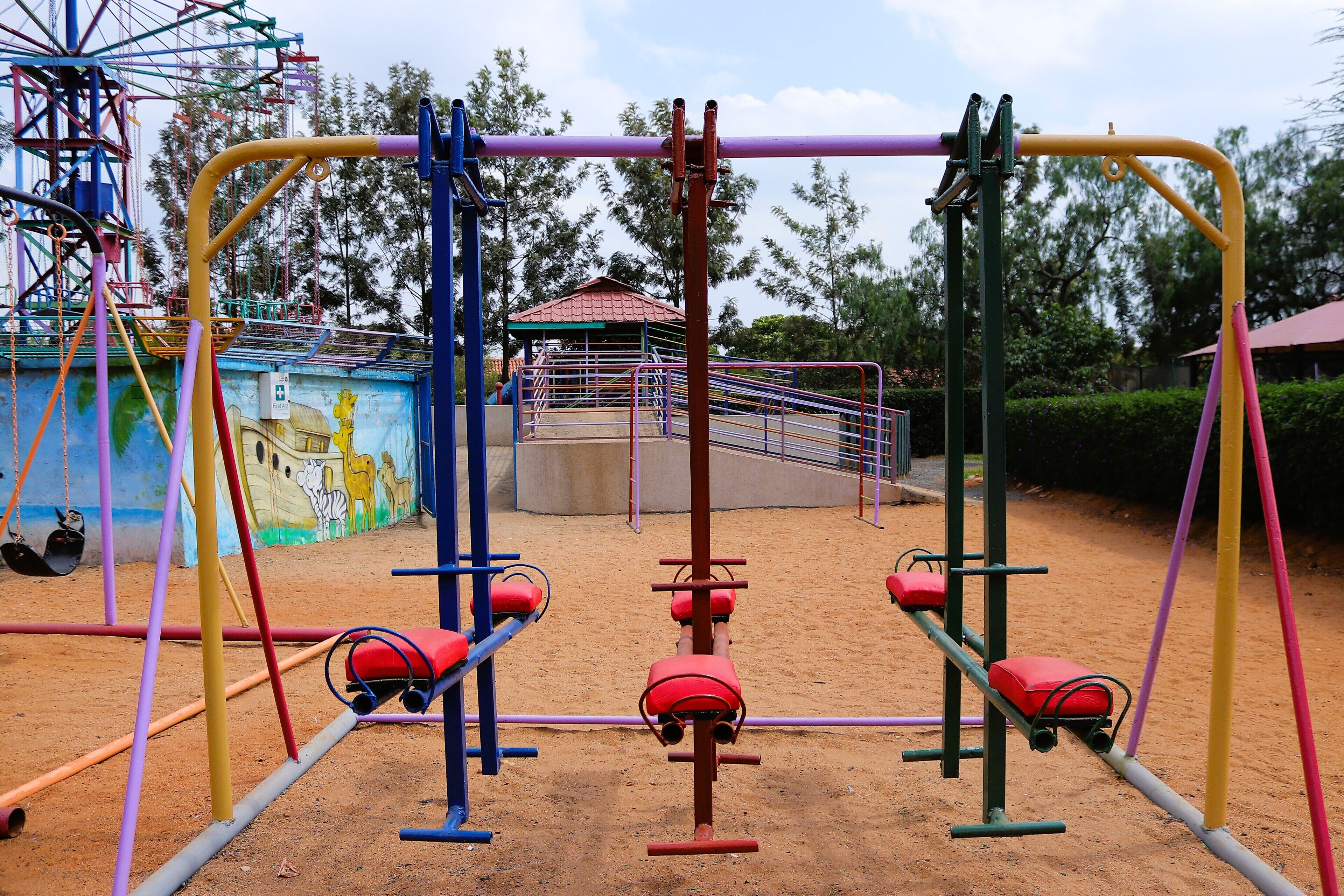 A playground with swings and a climbing structure.