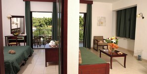 A hotel room with a balcony, a dining area, and a living space. - Chrousso Village (Kassandra)