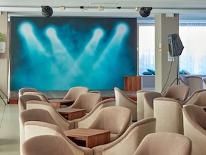 Meetings take place in this conference room with a unique mural and comfortable seating.