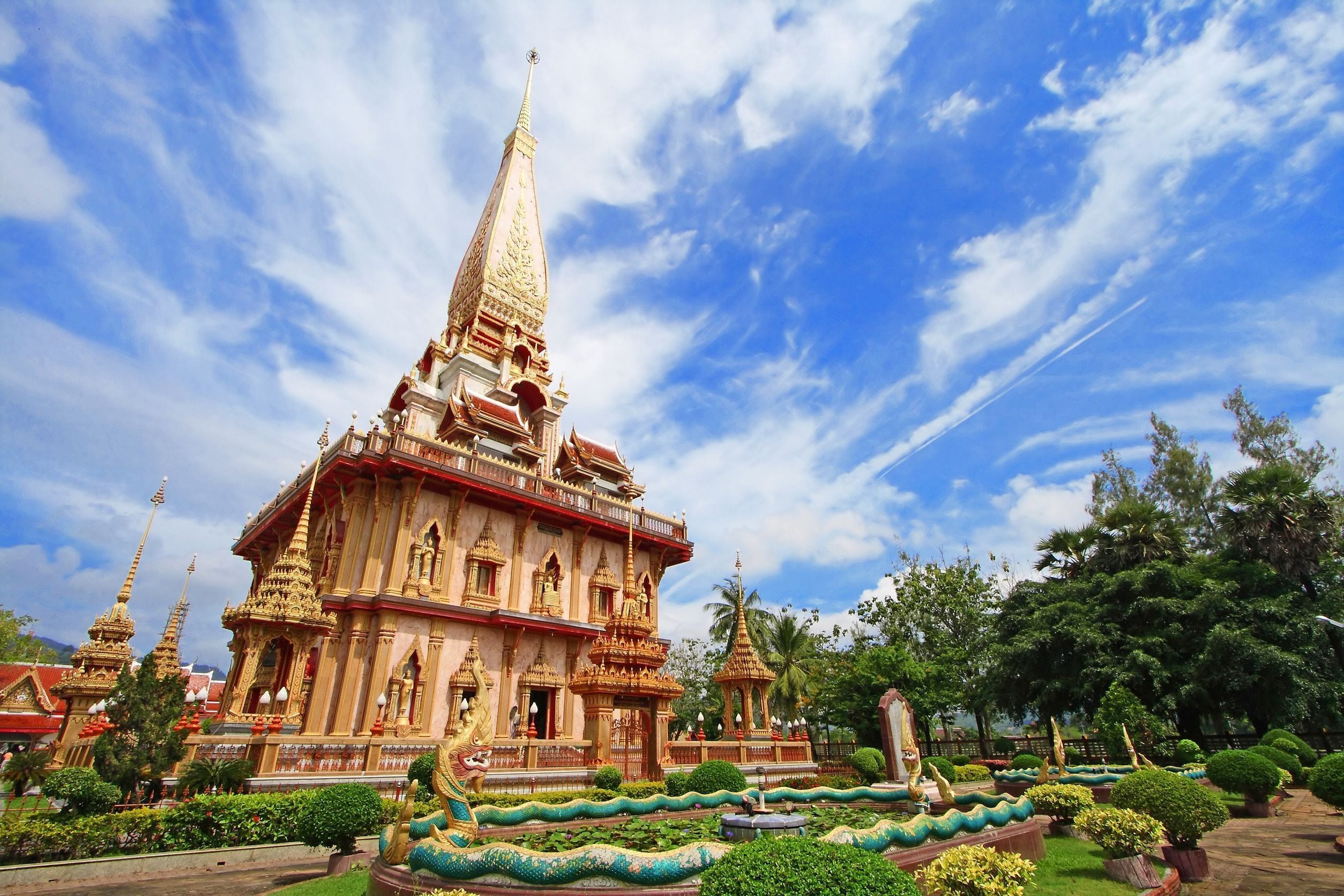 A large temple complex with multiple structures, including a prominent central building with a pointed roof and smaller surrounding buildings.