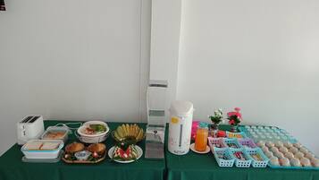 A breakfast buffet setup with various food items and beverages.
