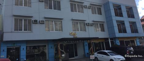 A multi-story hotel with a sign reading "Sabrah Suites".