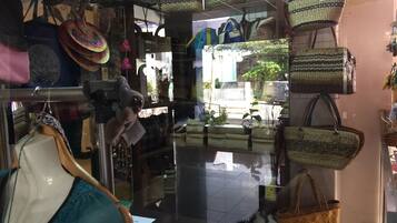 A store with various bags and hats displayed on shelves and hanging.