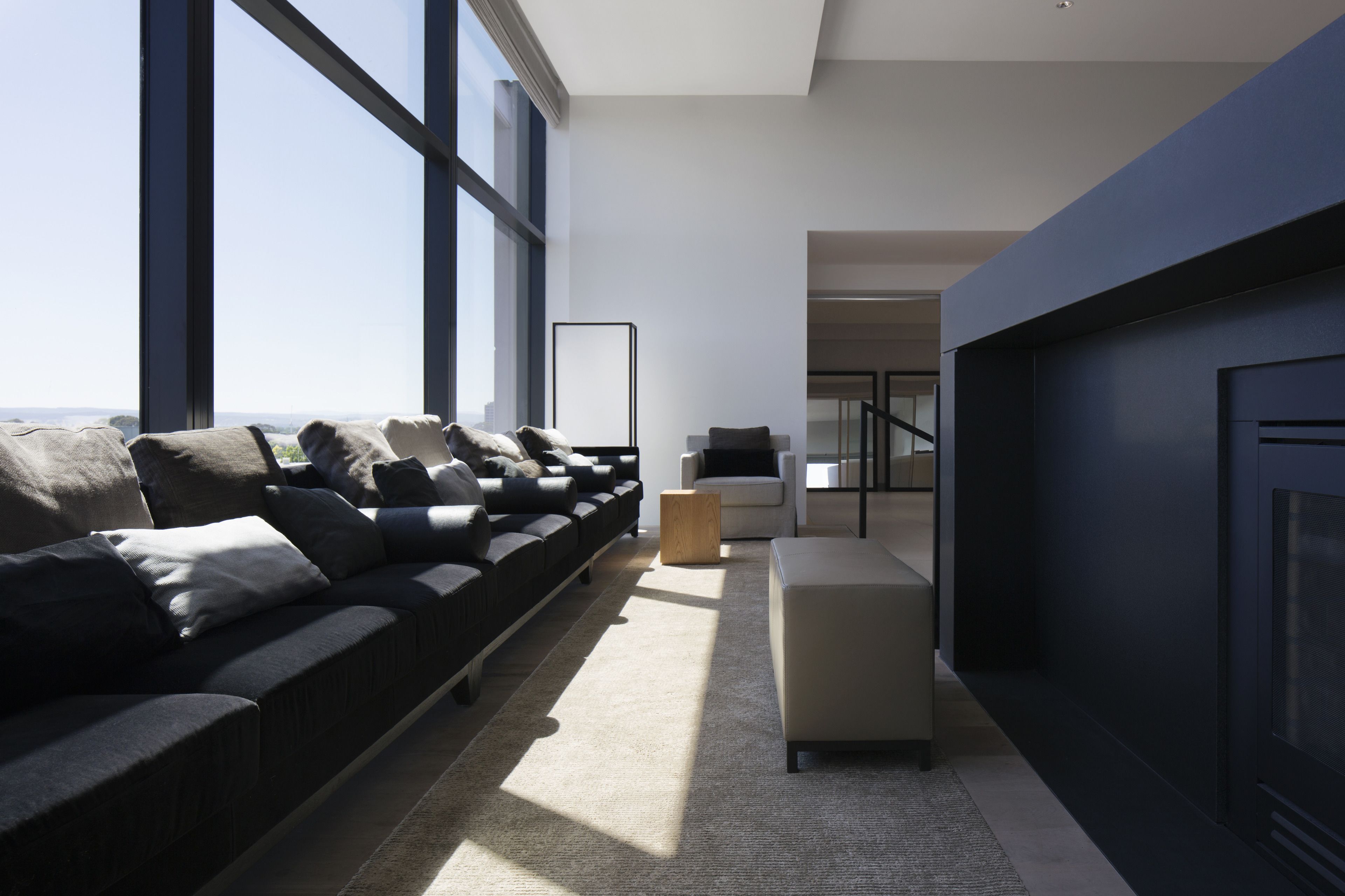 A modern living room with a sofa, a coffee table, and a fireplace.