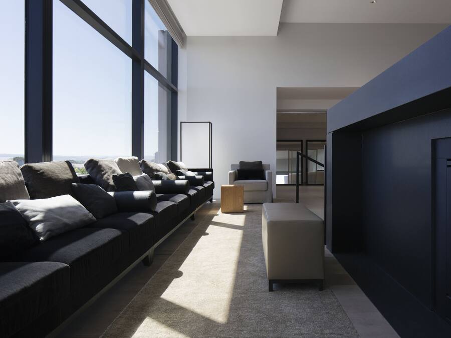 A modern living room with a sofa, a coffee table, and a fireplace.