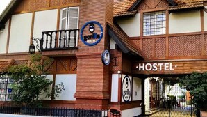 A hostel with a wooden facade, a balcony, and a sign indicating it is a gorilla hostel. - Gorilla - Hostel (Mendoza)