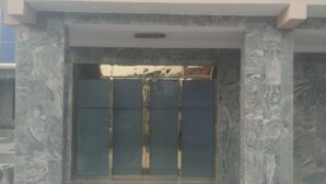 A building entrance with a glass door and a tiled floor. - GrandVenice Transit Apartments (Lagos)