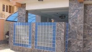 A building with a tiled facade, a staircase, and a balcony. - GrandVenice Transit Apartments (Lagos)