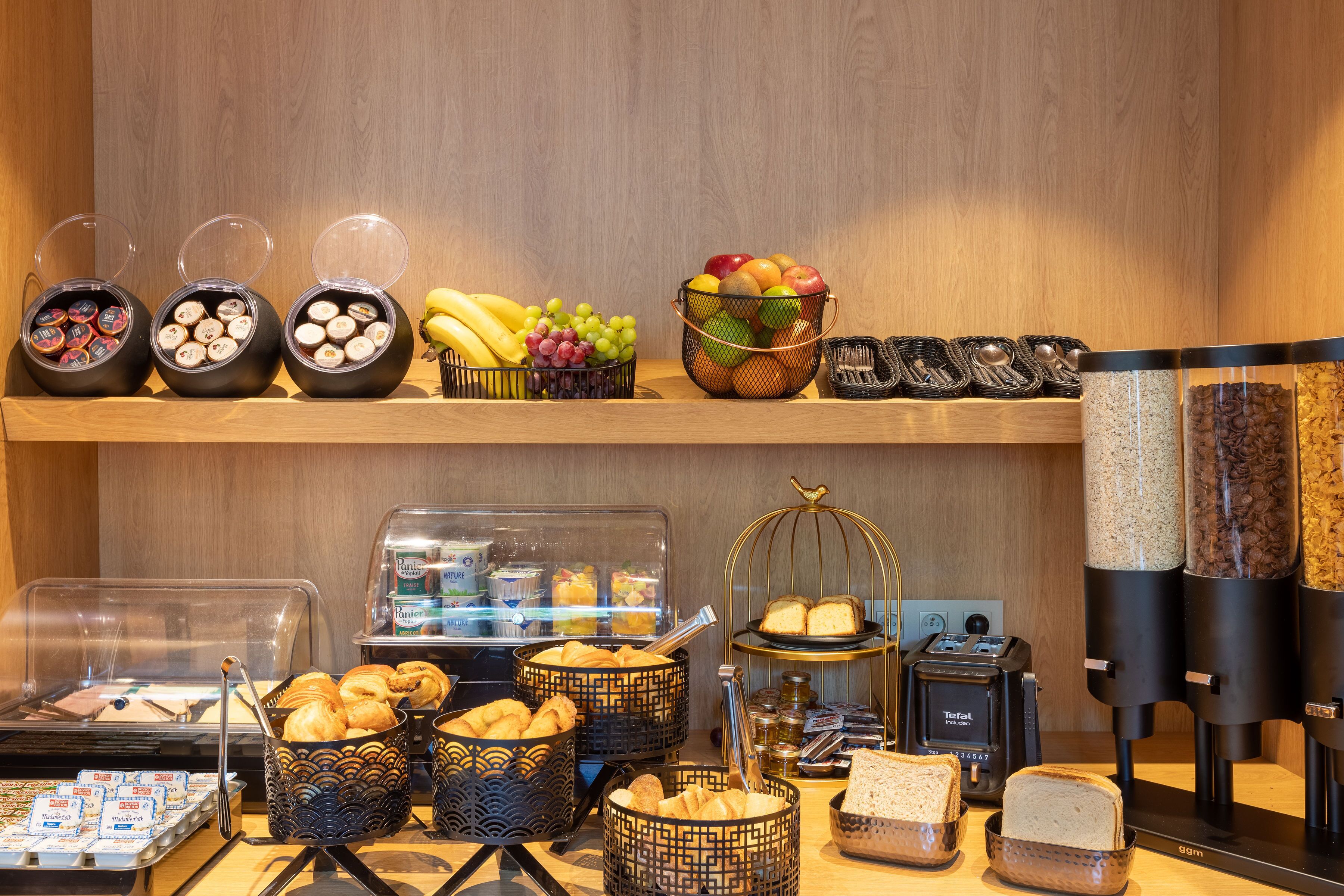 A breakfast buffet with various food items and a coffee machine.