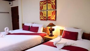 A hotel room with two beds, each with white linens and red accents, a wall-mounted artwork, and a bedside lamp. - Huenchandee (Chiang Rai)