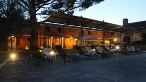 A patio area with sun loungers and a covered seating area, likely part of a hotel or resort. - Hotel Van Gogh (St.-Rémy-de-Provence)