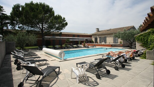 A poolside area with lounge chairs and a swimming pool.