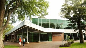 A modern building with a glass facade and a covered entrance area. - Saint Mary's University Residence Summer Accommodations (Halifax)