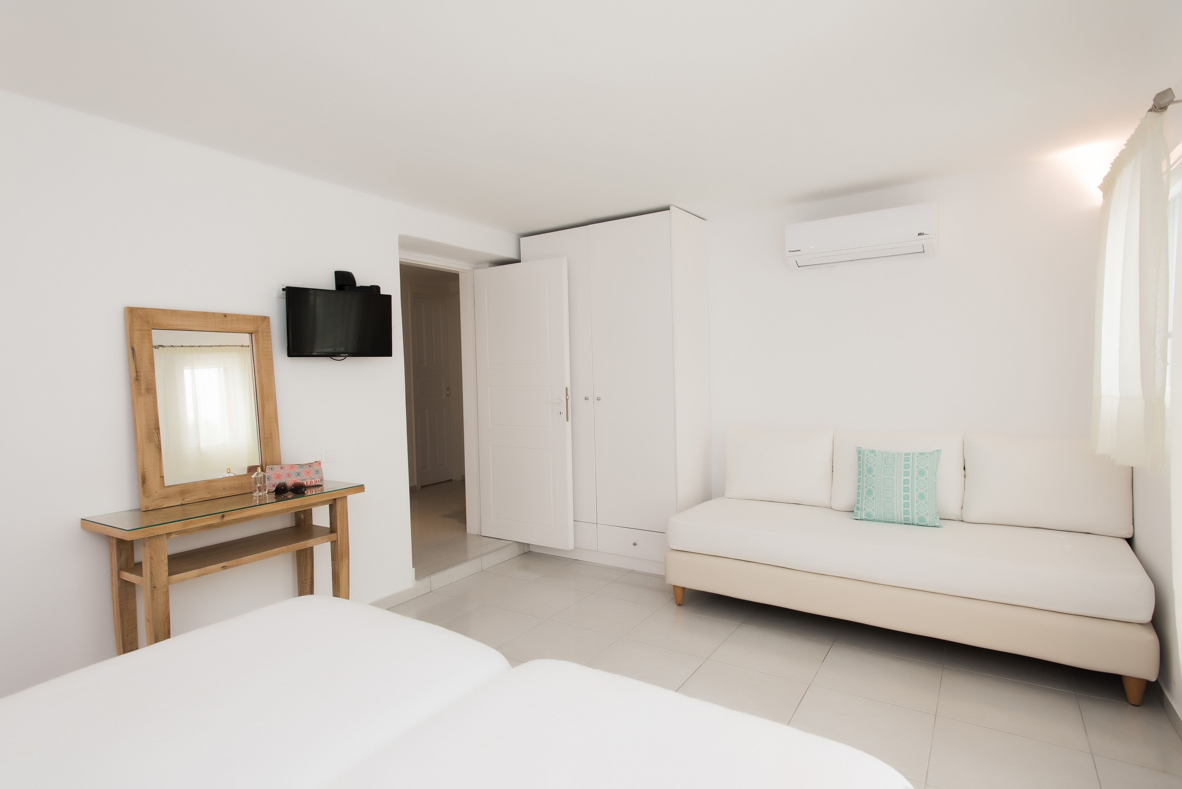 family room, garden view (deluxe) | in-room safe, soundproofing, iron/ironing board, free wifi