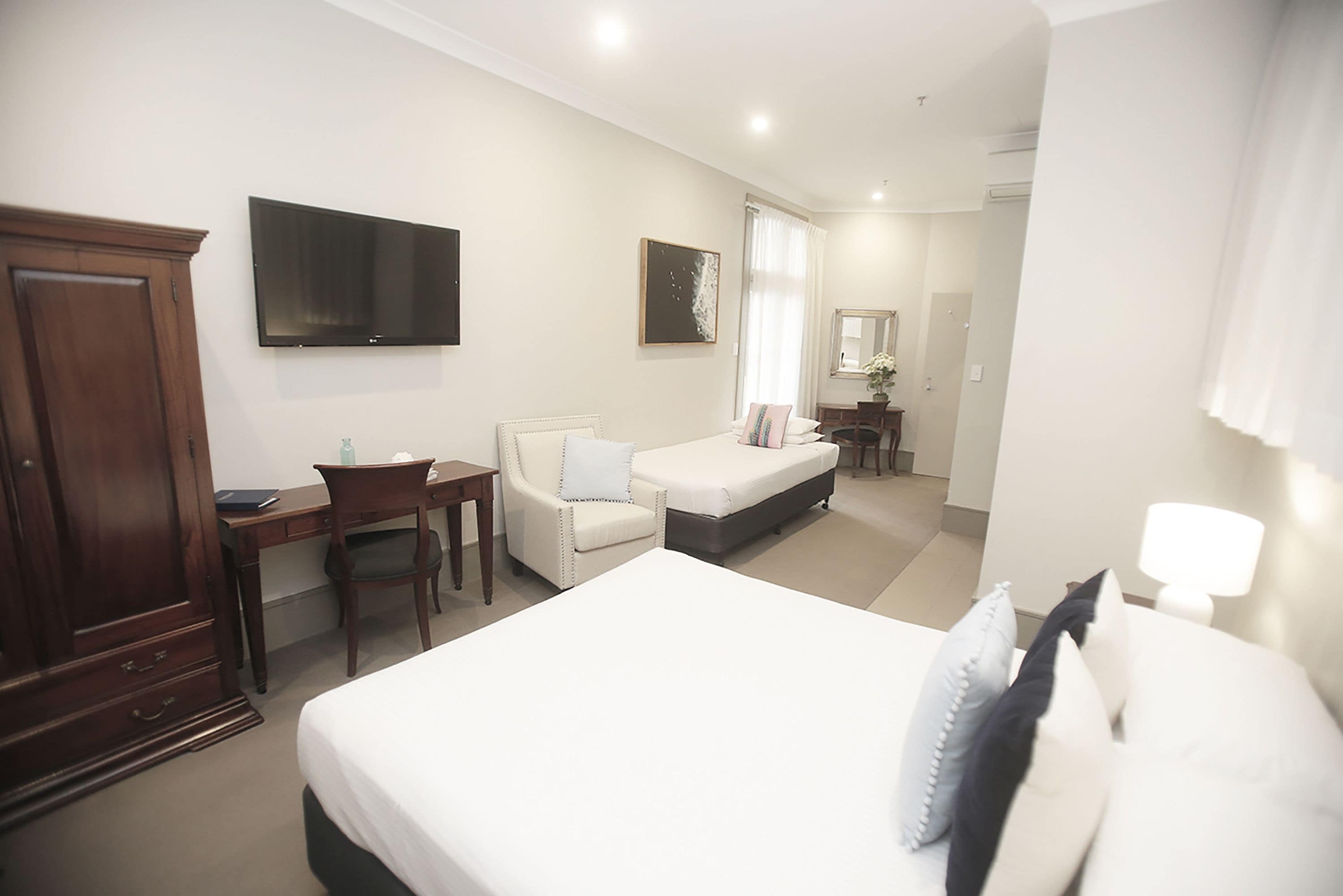 studio family suite (1 queen bed and 1 single bed) | 1 bedroom, in-room safe, desk, iron/ironing board