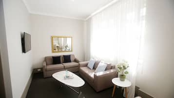 Family Suite, 2 Bedrooms | Living room | Flat-screen TV