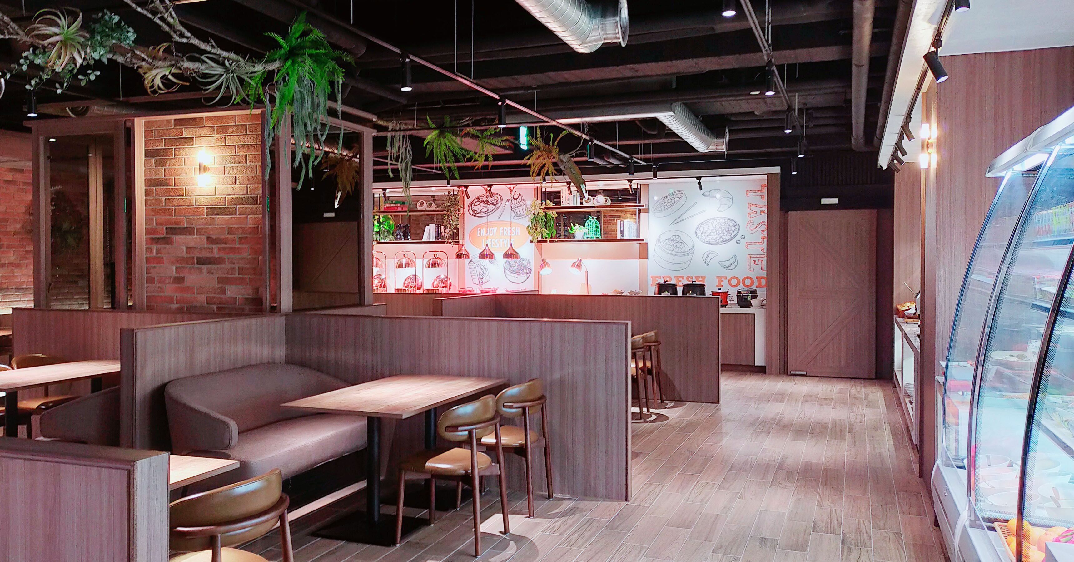 A restaurant with booths, a counter, and a display case.