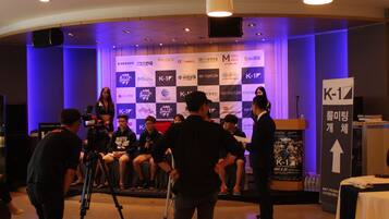 A conference room with a stage, seating, and a podium.