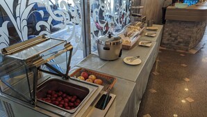 A buffet area with a variety of food items, including a container of apples and a bread display. - Waugh Den Hotel (Taichung)