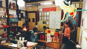 A traditional Chinese restaurant with wooden furniture, a counter, and various decorations including a large dragon balloon. - Smalleye Backpacker (Lukang)