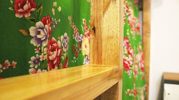 A wooden railing with a floral-patterned fabric backdrop.