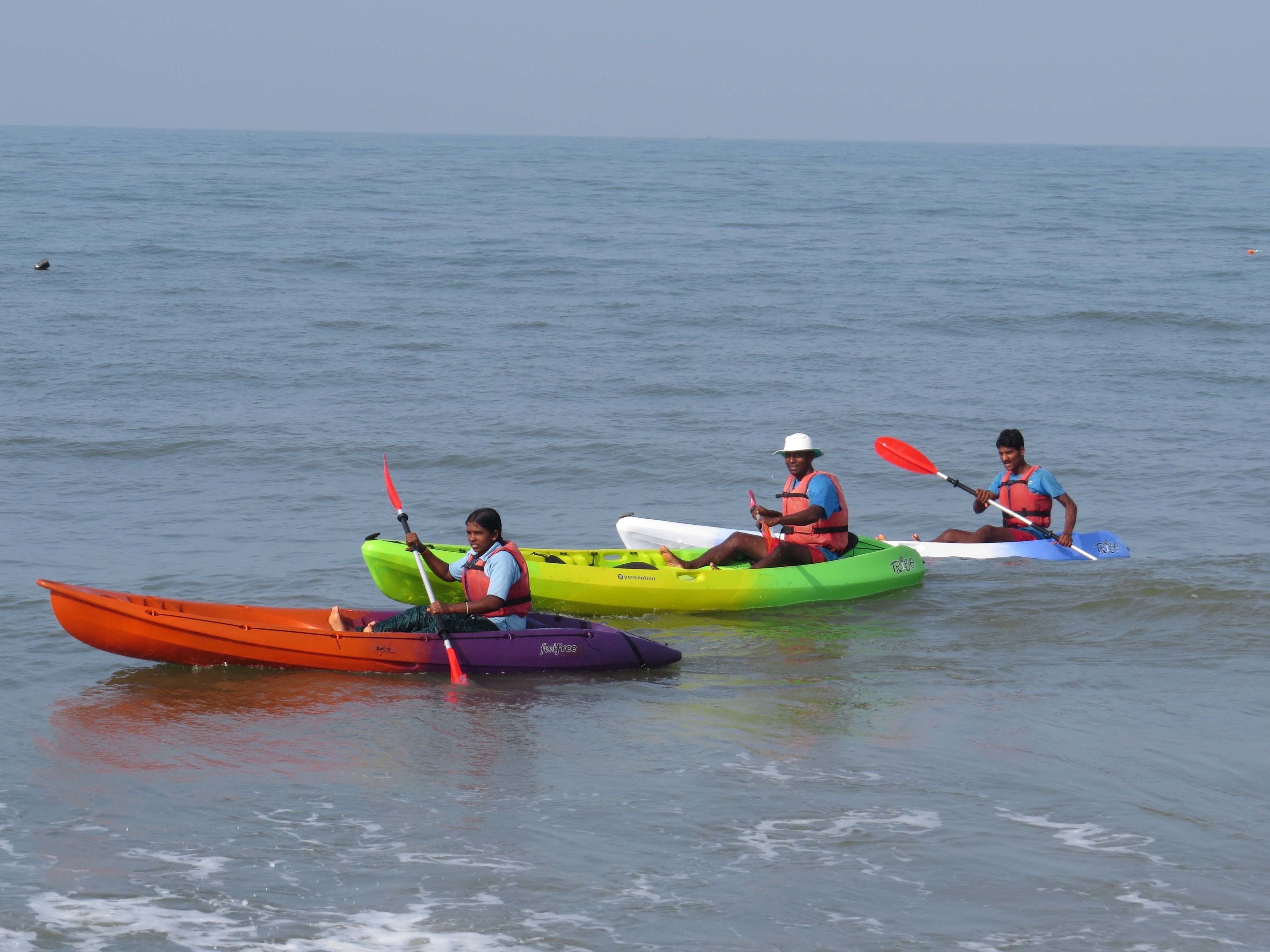 Three kayaks on calm water.