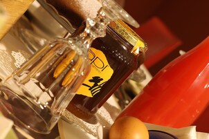 A bottle with a yellow label and a honeycomb design.