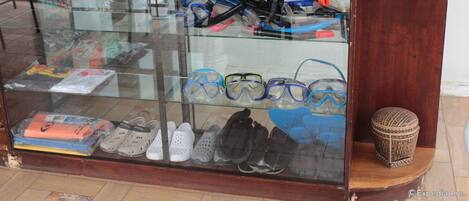 A display case with various swimming goggles and shoes.