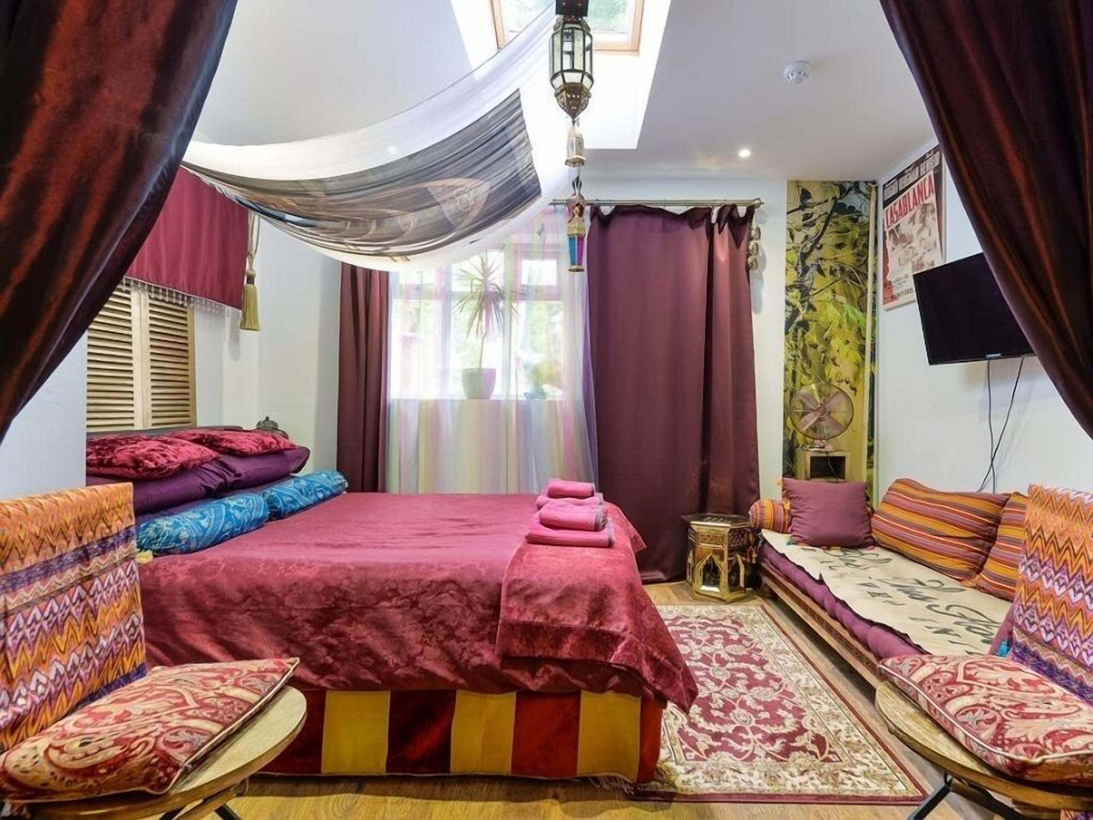 A room with a bed, a sofa, and a small table.