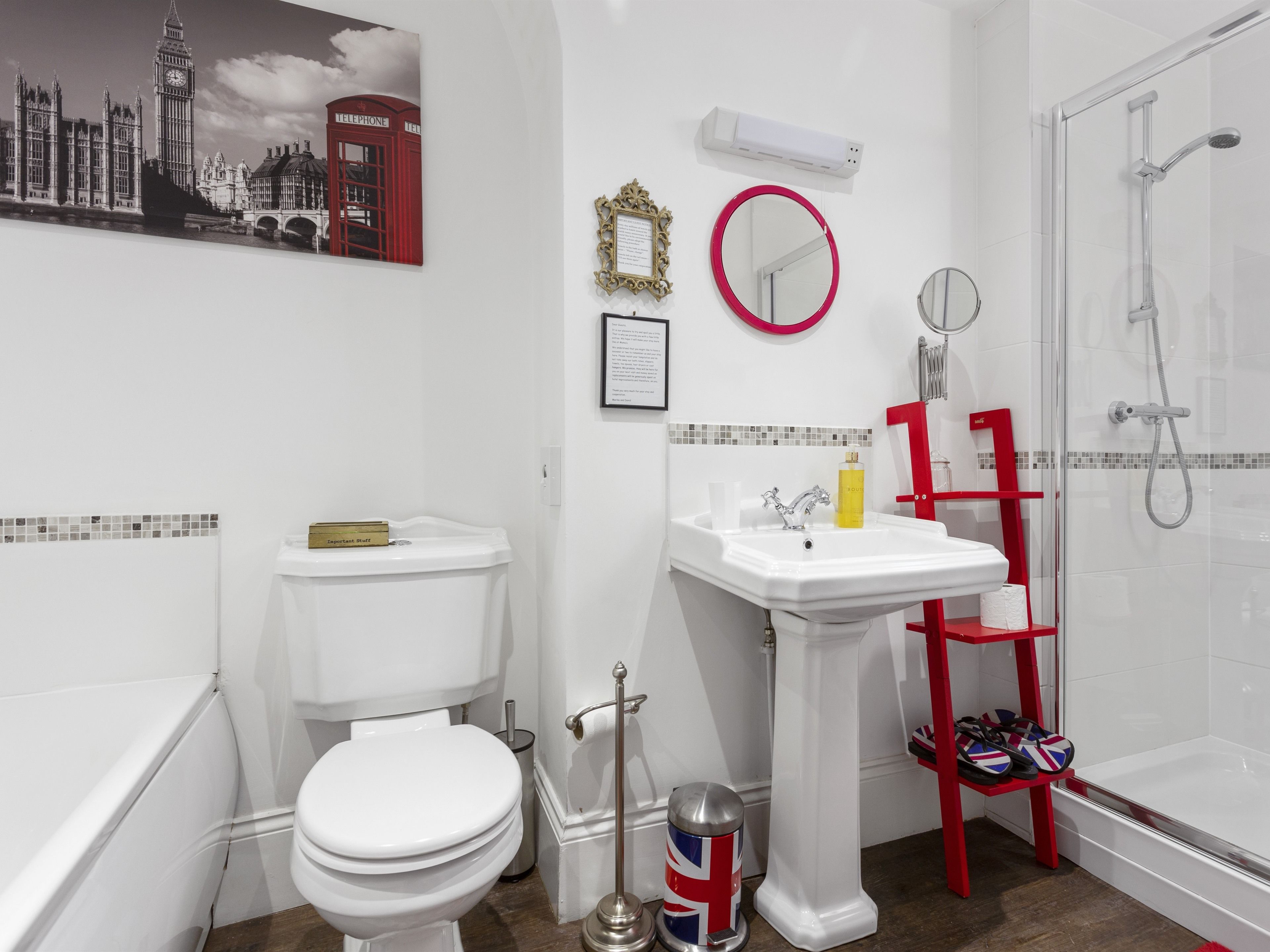 A modern bathroom with a toilet, sink, and shower.